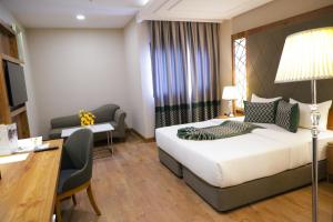 a hotel room with a bed and a desk and a chair at UNITED HOTEL INTERNATIONAL in Yaoundé