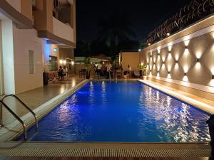 a swimming pool in a hotel at night at Hotel Golf Coast in Kinshasa