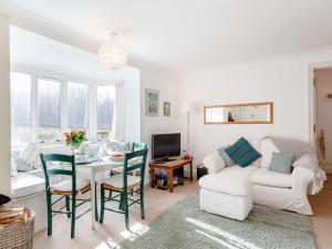 a living room with a table and a white couch at 3 Bed in Turriff 75489 in Turriff