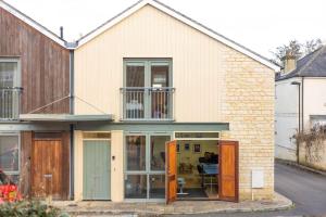 a house with sliding glass doors and windows at The Wellness Lodge- Gym, Table Tennis, Cinema, Parking and more! in Bath