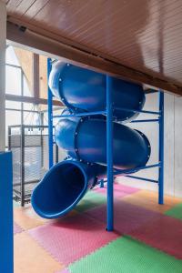 a blue slide on a playground in a room at Kokotel Krabi Ao Nang in Ao Nang Beach