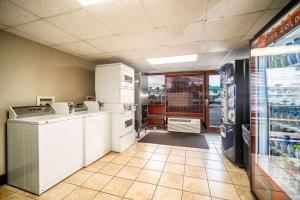 a kitchen with white appliances in a store at La Quinta by Wyndham Cocoa Beach Oceanfront in Cocoa Beach