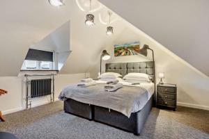 a bedroom with a large bed in a attic at The Nook, Winchcombe in Winchcombe