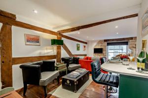 a living room with a couch and a table at The Nook, Winchcombe in Winchcombe