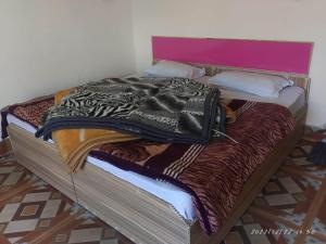 a bed in a room with at Hotel Rocks and pine Auli in Joshīmath