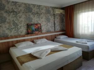 Postel nebo postele na pokoji v ubytování Grand Ece Hotel