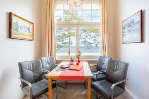 a dining room with a table and chairs and a window at Villa Carmen in Bansin