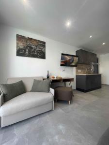 a living room with a couch and a table at Les Loges du Luberon in Coustellet