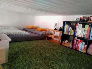 a bedroom with a bed and a book shelf with books at SweetHome Brno - celý byt in Komárov +6 photos