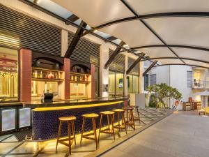 a restaurant with a bar with stools around it at ibis Styles Goa Vagator - An Accor Brand in Vagator