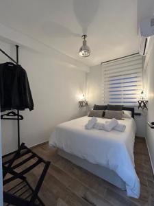 - une chambre avec un grand lit blanc et un tripod dans l'établissement AT Góngora 11 con Parking, à Cordoue