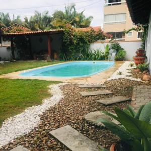 a swimming pool in the backyard of a house at Pousada Lira Haus in Pomerode