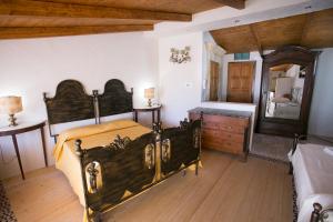 a bedroom with a bed and a dresser and a mirror at Hotel Villa Antica Tropea in Tropea