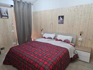 a bedroom with a bed with a red blanket at ROMEO2 in Somma Lombardo