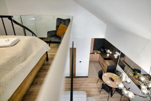 a bedroom with a bed and a table and a chair at Apartamenty Laguna Beskidów - C50 in Zarzecze