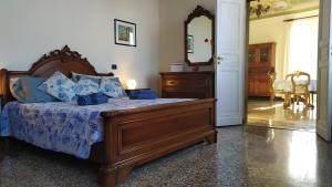 a bedroom with a large wooden bed with blue pillows at Casa Teresina a Camogli in Camogli