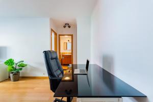 an office with a desk and a chair and a laptop at Olaias Flat (with Free Parking) in Lisbon