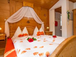 a bedroom with a bed with flowers on it at Guest house pension Neumayer in Fieberbrunn