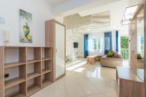 a living room with a staircase in a house at Apartments Mimoza in Baška