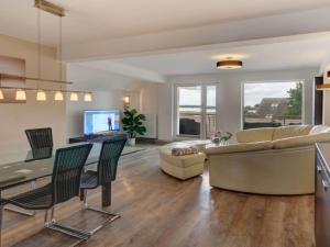 a living room with a couch and a table at Holiday apartment Schliekieker in Kopperby