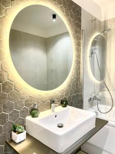 a bathroom with a white sink and a mirror at STUDIO 92- URBAN PLAZA in Braşov +76 photos
