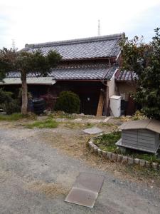 a house with a garage and a driveway at Japanese old house in Takatsuki