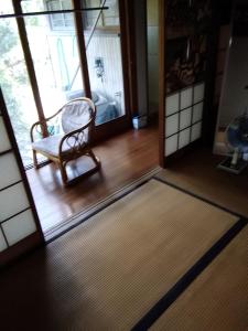 a room with a chair and a rug on the floor at Japanese old house in Takatuki