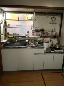a kitchen with a sink and a counter top at Japanese old house in Takatsuki