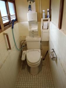 a small bathroom with a toilet in a room at Japanese old house in Takatsuki