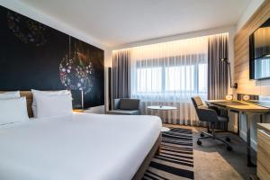 a hotel room with a bed and a desk at Novotel Amsterdam City in Amsterdam +37 photos