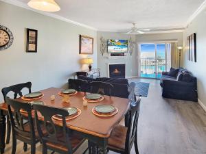 a dining room and living room with a table and chairs at Mariners Watch 304 - Luxury Bayview Condo in Ocean City