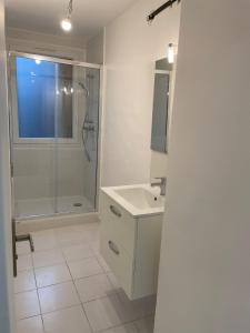 a white bathroom with a shower and a sink at 5 people/Paris-CDG/France Stadium in Bagnolet
