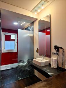 a bathroom with a sink and a mirror at Maroa Hotel in Vigo