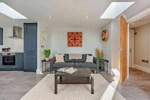 a living room with a couch and a table at The Nook in Burford