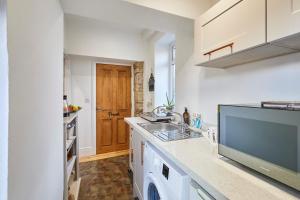 a kitchen with a sink and a counter top at Host & Stay - Millers Coach House in Hexham