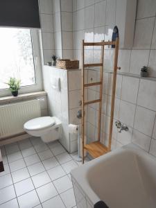 La salle de bains est pourvue de toilettes, d'un lavabo et d'une baignoire. dans l'établissement NEU - Familienfreundlich - Für bis zu 6 Personen, à Oberhof