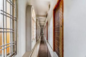 an empty corridor in a building with windows at Solar Inn in Tirupati