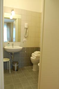 a bathroom with a sink and a toilet and a mirror at Bella Cagliari B&B in Cagliari