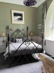 a bedroom with a bed and a couch and a window at The Old Schoolhouse in Morar