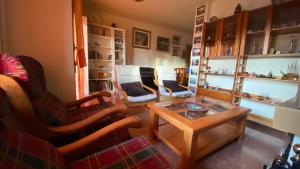 a living room with chairs and a coffee table at Apartament Vila Vermella, PRADES in Prades