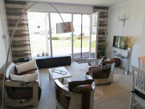 a living room with a couch and chairs and a tv at Villa Seeblick - ABC223 in Bad Kleinen