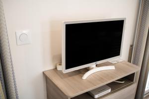 a computer monitor sitting on top of a wooden shelf at Càmping Bellsol in Pineda de Mar