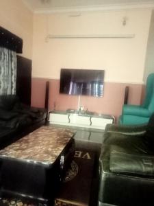 a living room with a couch and a table at CRYSTAL SUITES in Akure