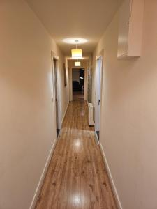 an empty hallway of a home with a hard wood floor at Penthouse Apartment in Kilkenny