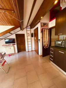 a large room with a kitchen with a counter at Ca' Berio 67 in Imperia