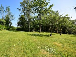 a field of grass with trees in the background at 1 Bed in South Molton 3.1 miles SE 91153 in George Nympton