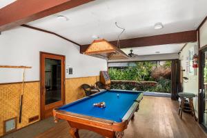 a living room with a pool table in it at White Sands Village#213 in Kailua-Kona