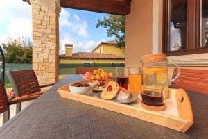 a tray of food on a table with a drink at Villa Aurora by Istrialux in Svetvinčenat