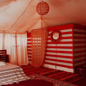 a room with a tent with a bed in it at Rimal tata camp 