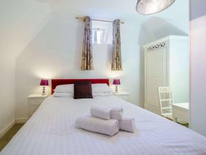 a bedroom with a large white bed with two pillows at 3 Bed in Hawkshead Village LLH21 in Hawkshead